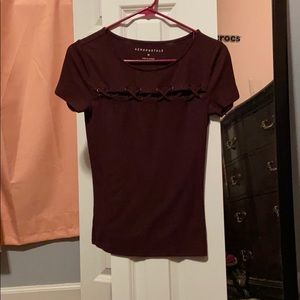 Tee shirt with crosses across the chest